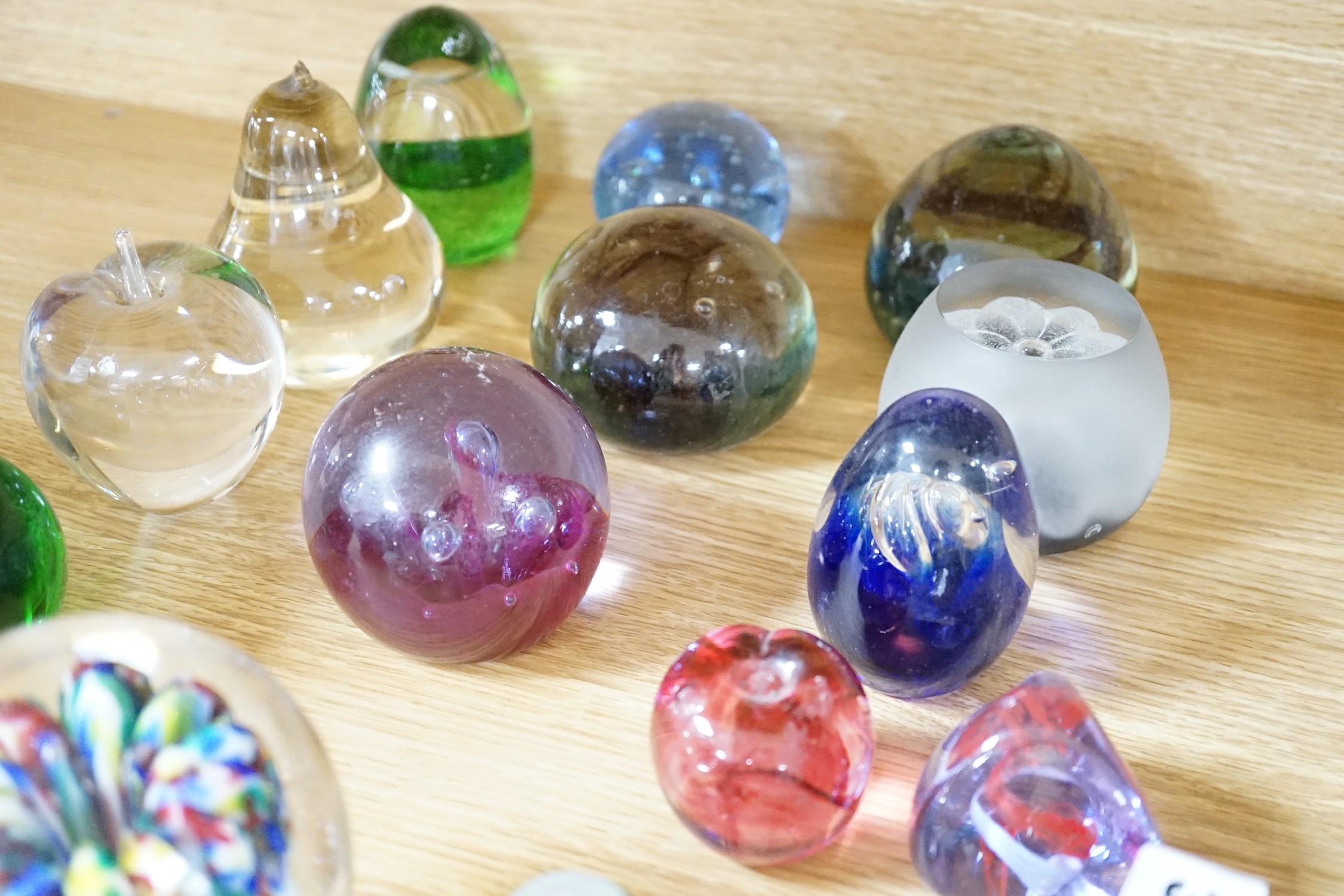 A collection of mixed paperweights to include a faceted floral Perthshire example, other Scottish floral and millefiori examples (Qty), tallest 12cms high
